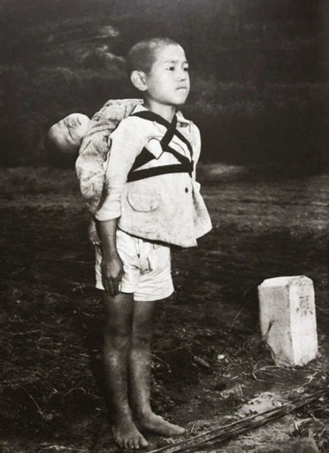 japanese-boy-standing-attention-brought-dead-younger-brother-cremation-pyre-1945s.jpg